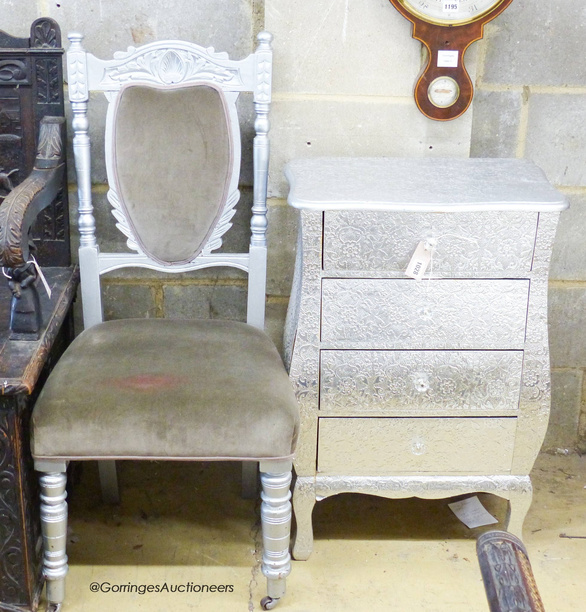 An embossed silvered four drawer small chest, W.52cm D.34cm H.80cm., and a silver painted dining chair
